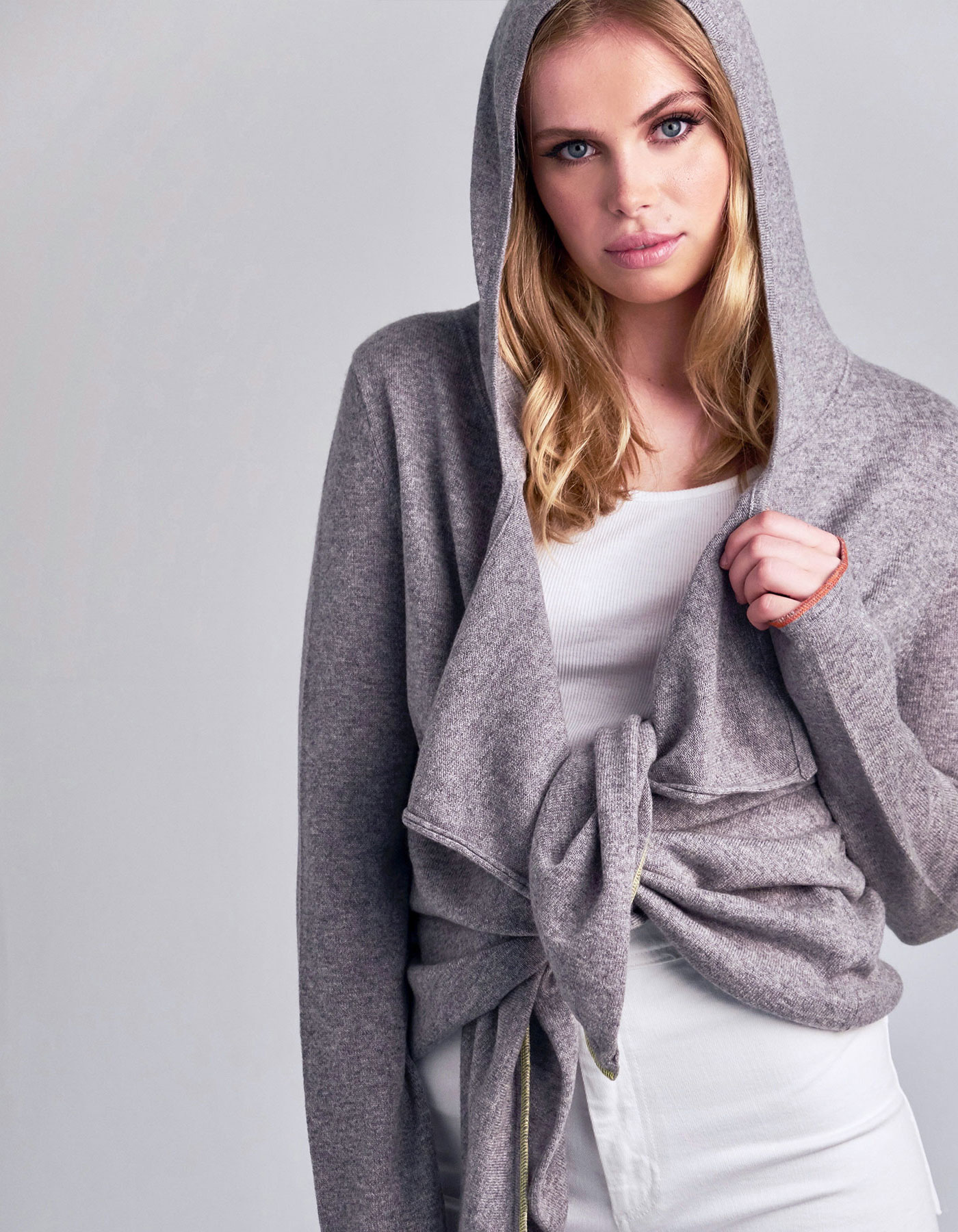 Studio photo of model in designer knitwear, the malin darlin cashmere tie hoody.