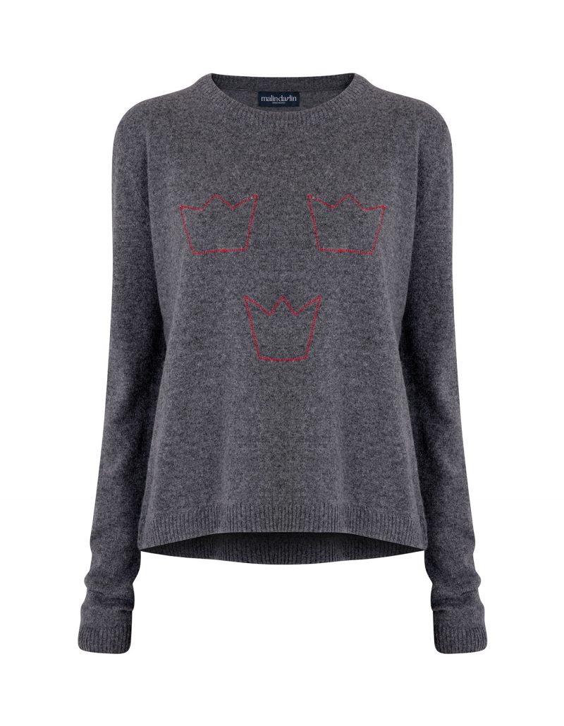 A grey designer cashmere jumper with three red crowns knitted into the pattern.