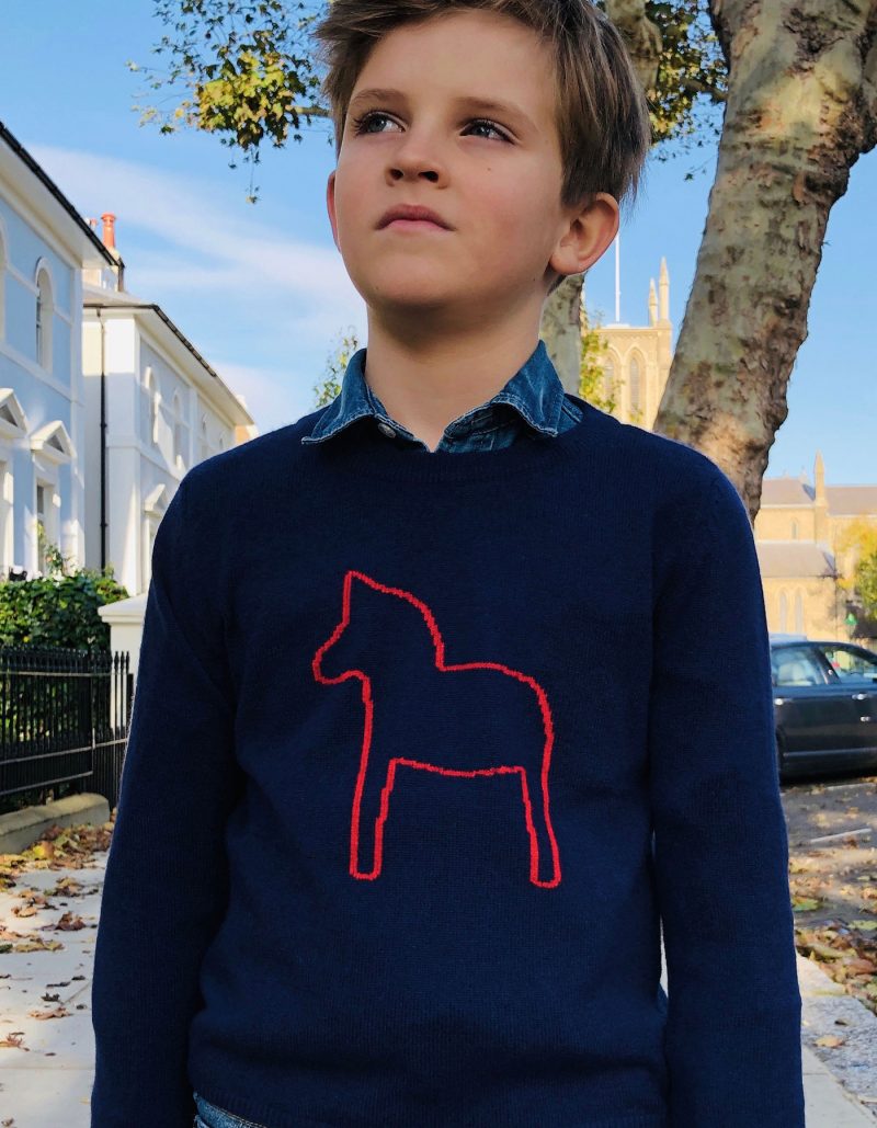 Boy wearing childrens cashmere, the malin darlin Little Pony Navy cashmere jumper.