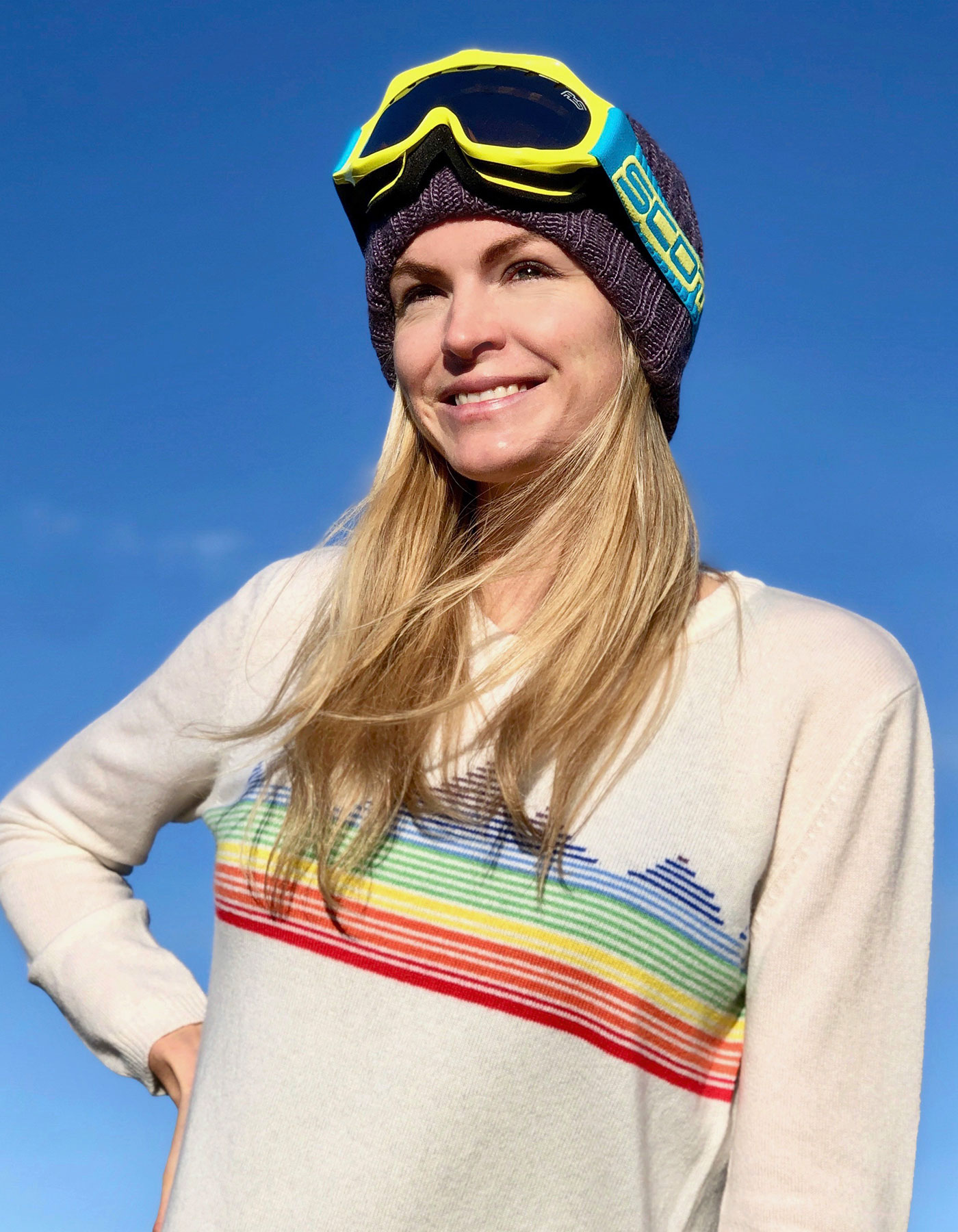 Woman in a Rainbow Mountain jumper to promote lady kilas charities designer cashmere jumpers at malin darlin.