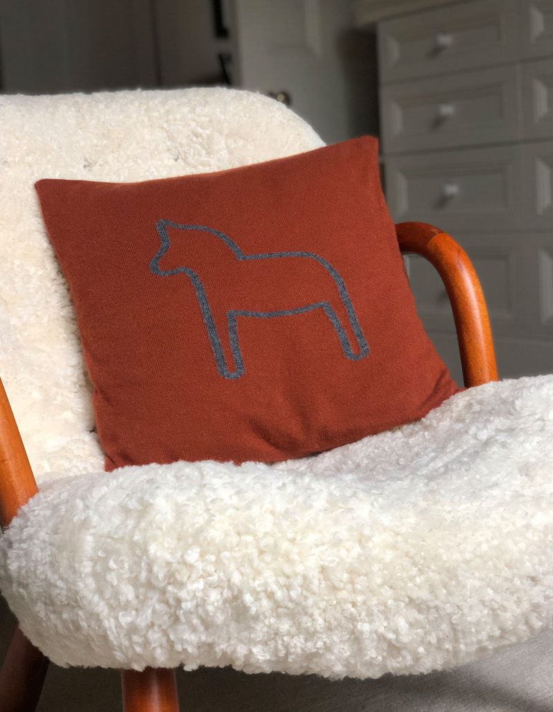 Image of a rust coloured designer cashmere cushion cover, part of the malin darlin range of cashmere gifts.